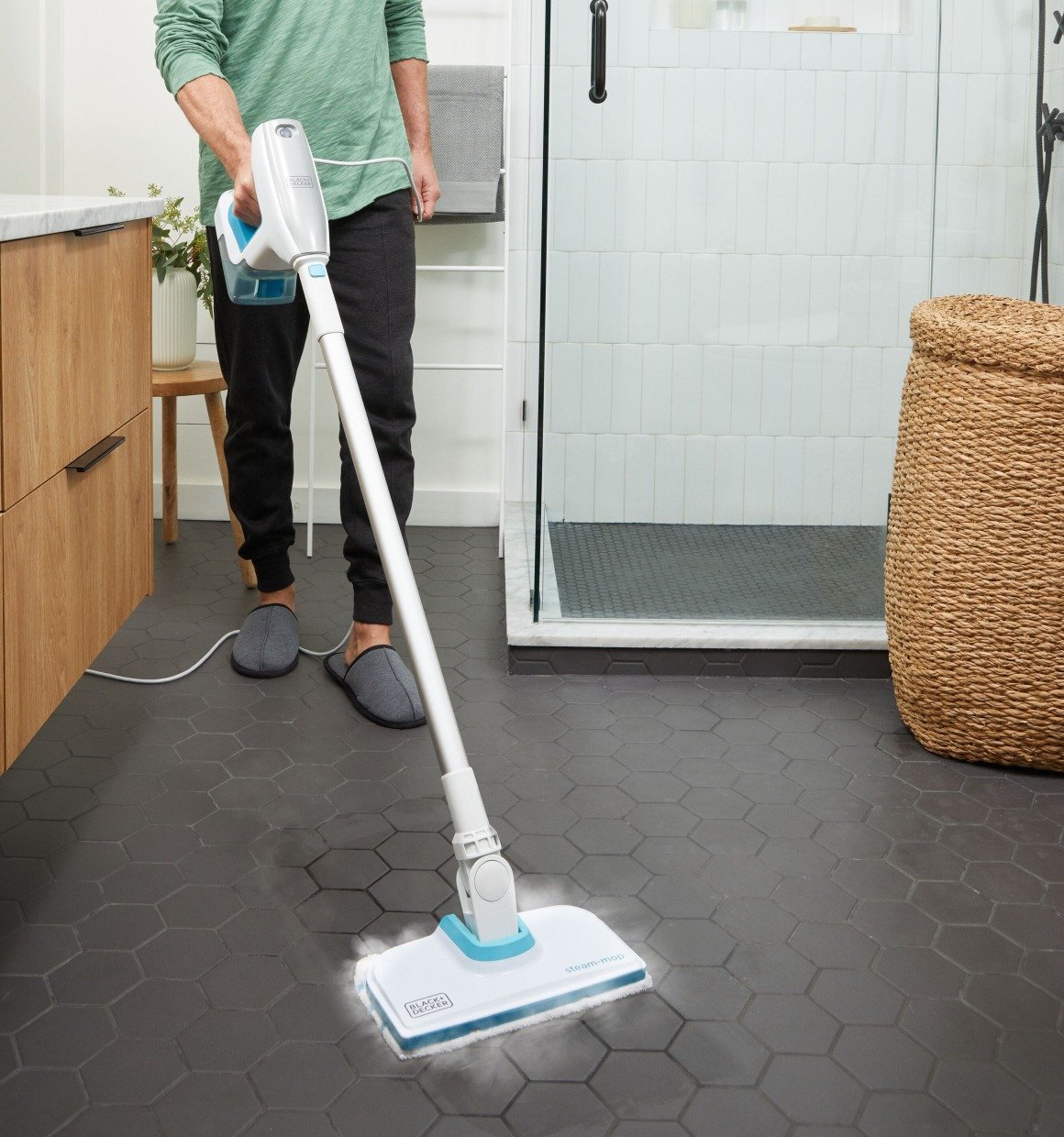 Person using BLACK+DECKER 8 piece Steam Mop system to clean tile floor in bathroom.