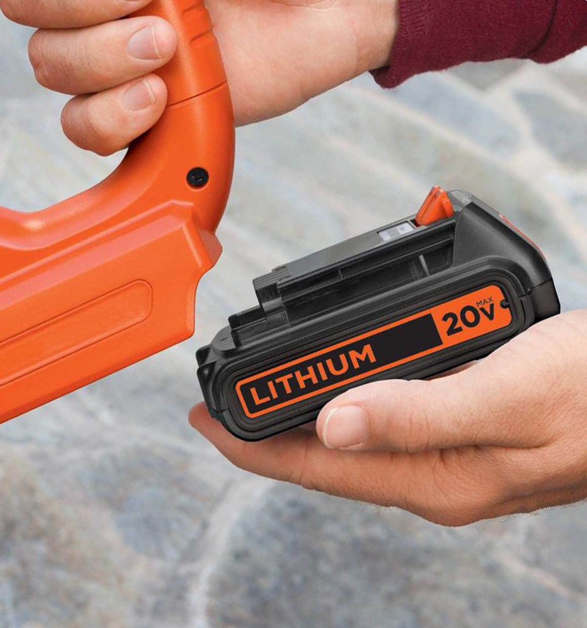 Person putting a black and decker 20 volt lithium battery onto a cordless tool.