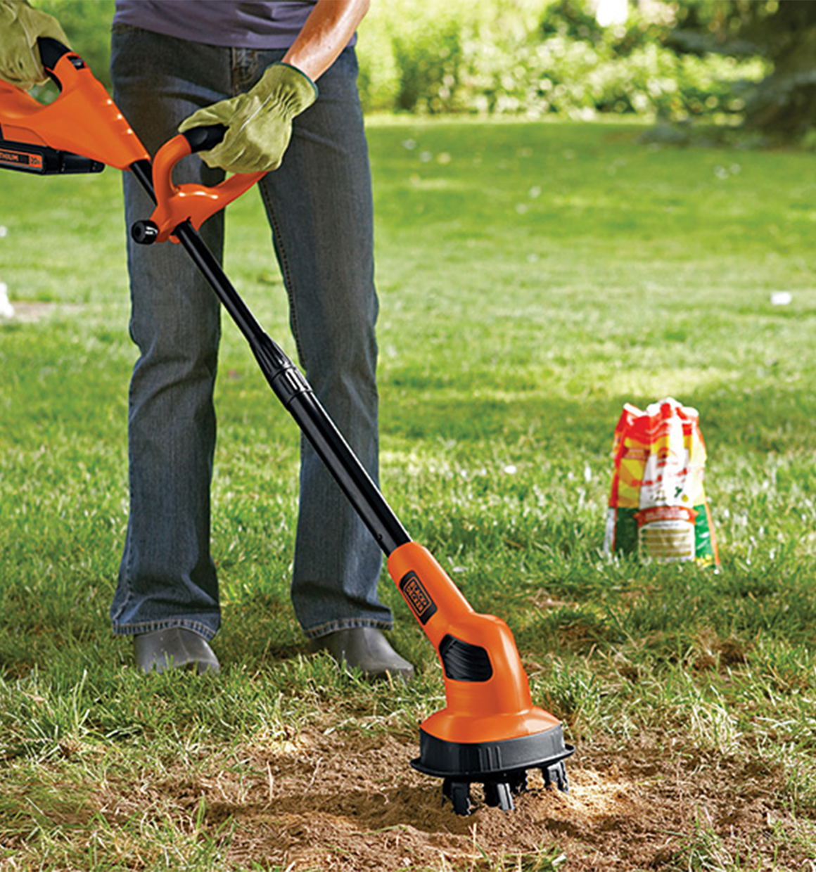 20 volt MAX Lithium Garden Cultivator Battery and Charger Not Included being used by a person outdoors.