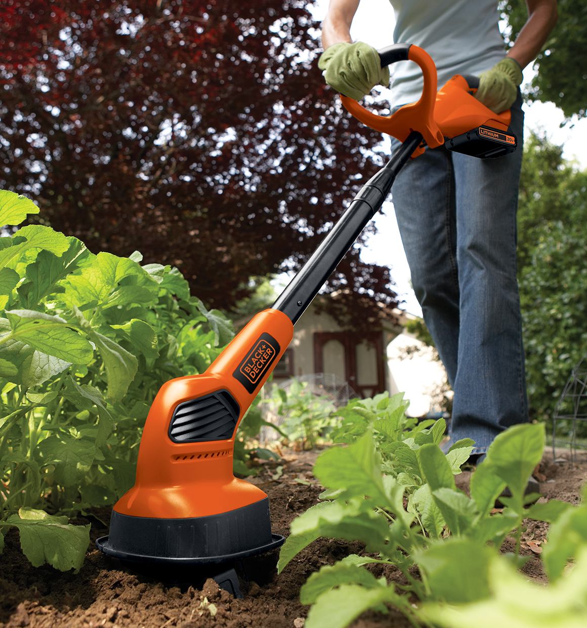 20 volt MAX Lithium Garden Cultivator Battery and Charger Not Included being used by a person outdoors.