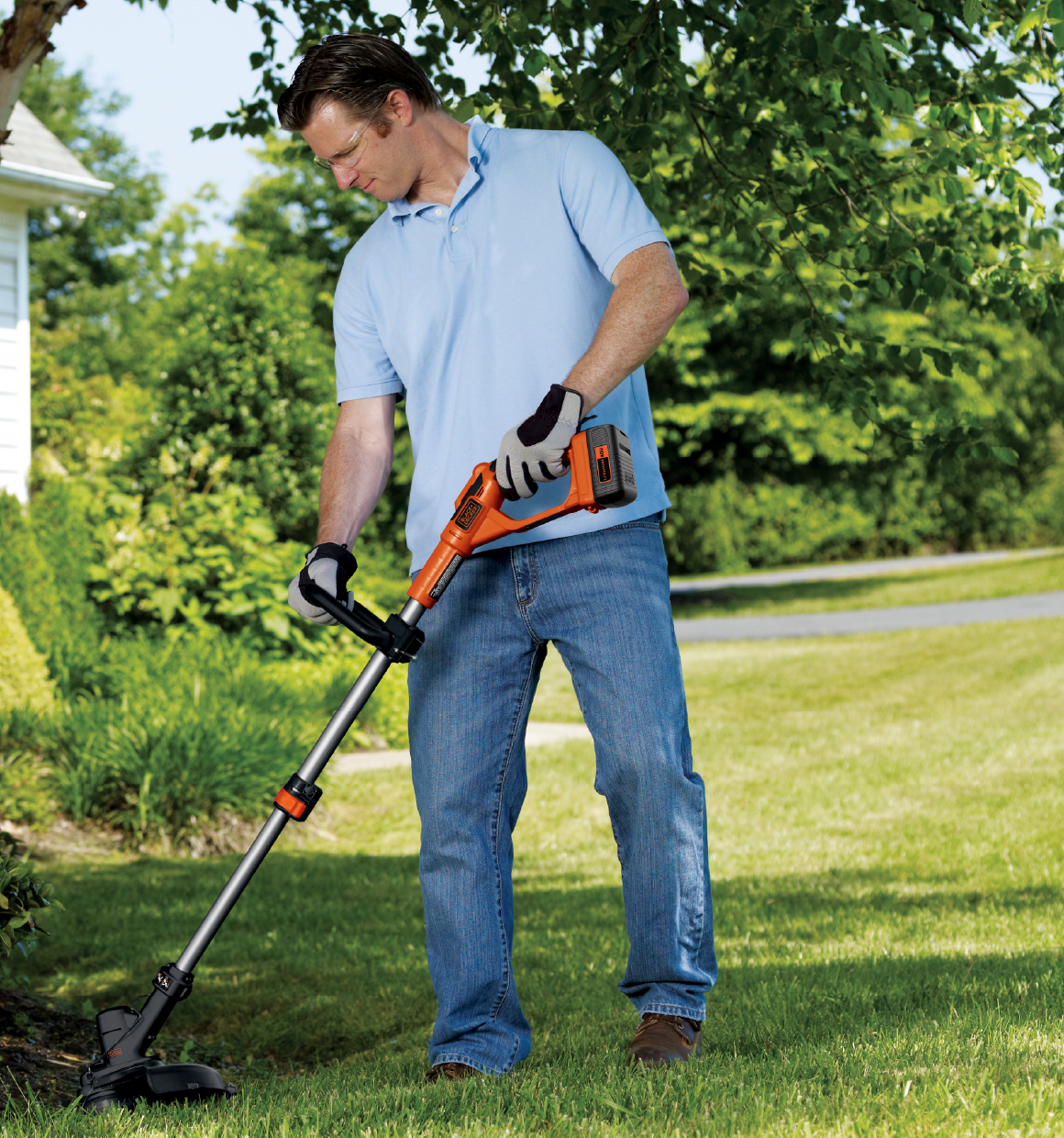 Lithium String Trimmer with powercommand being used by person to trim bushes.