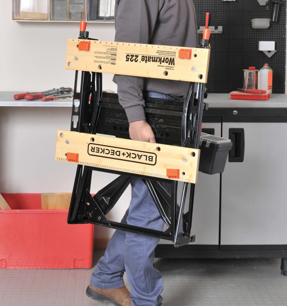 Workmat 225 Portable Work Center and Vise being carried by a person.
