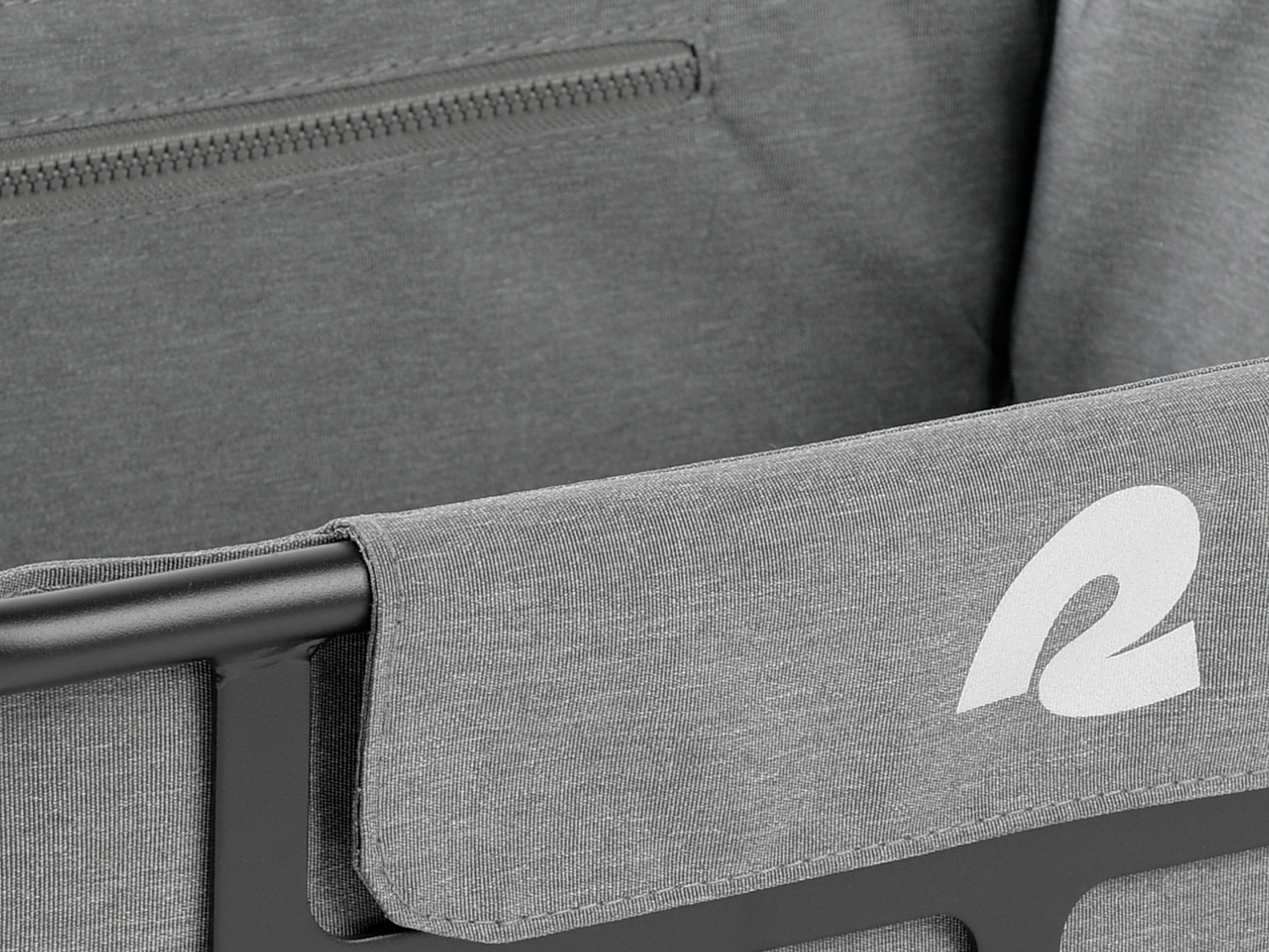 Close-up of a the gray fabric liner with a zipper featuring a white stylized logo and attached the black metal EverythingBin Rear Rack EBike Basket.