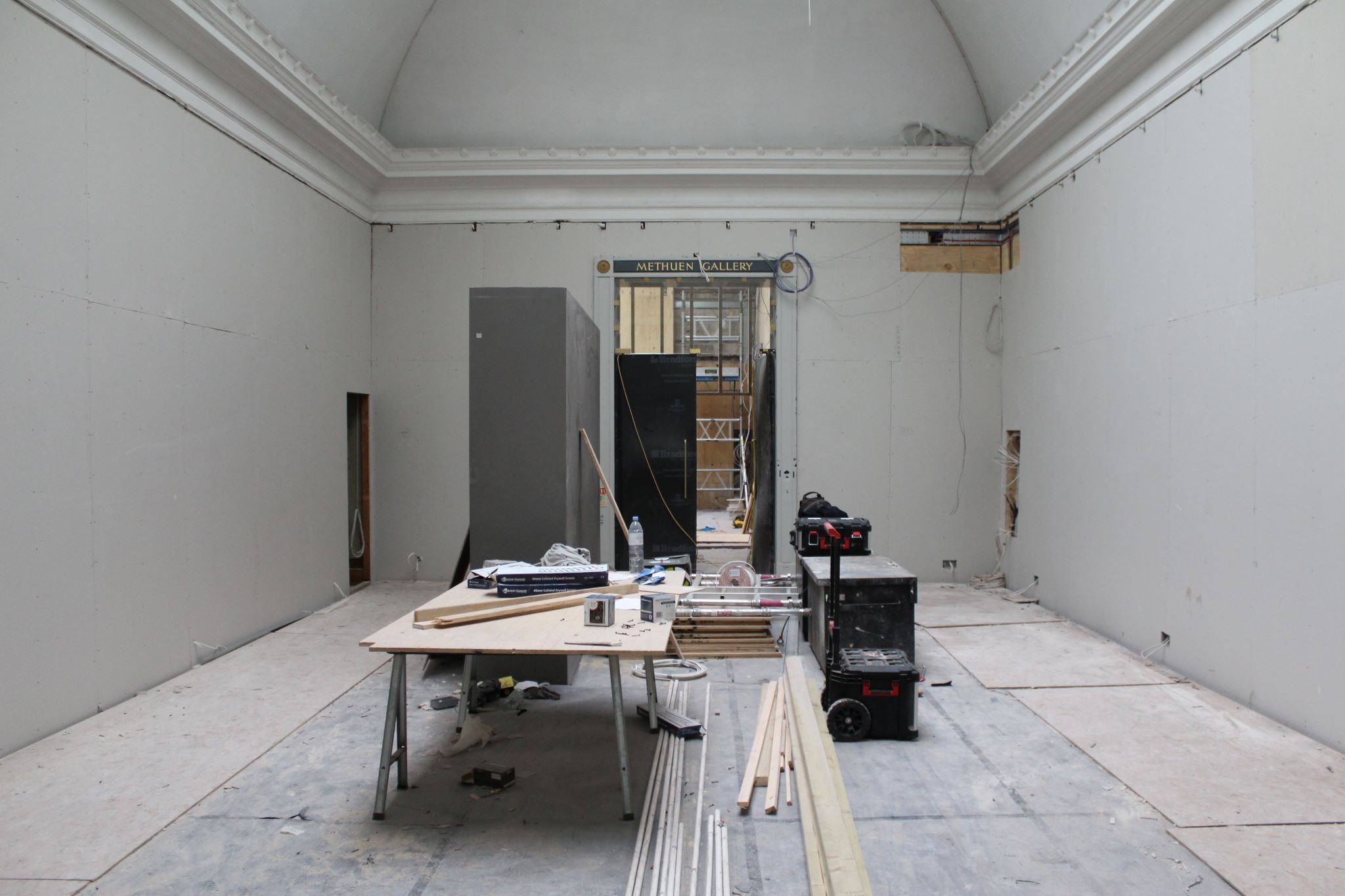RWA gallery with plasterboard on the walls and work equipment in the centre of the room 
