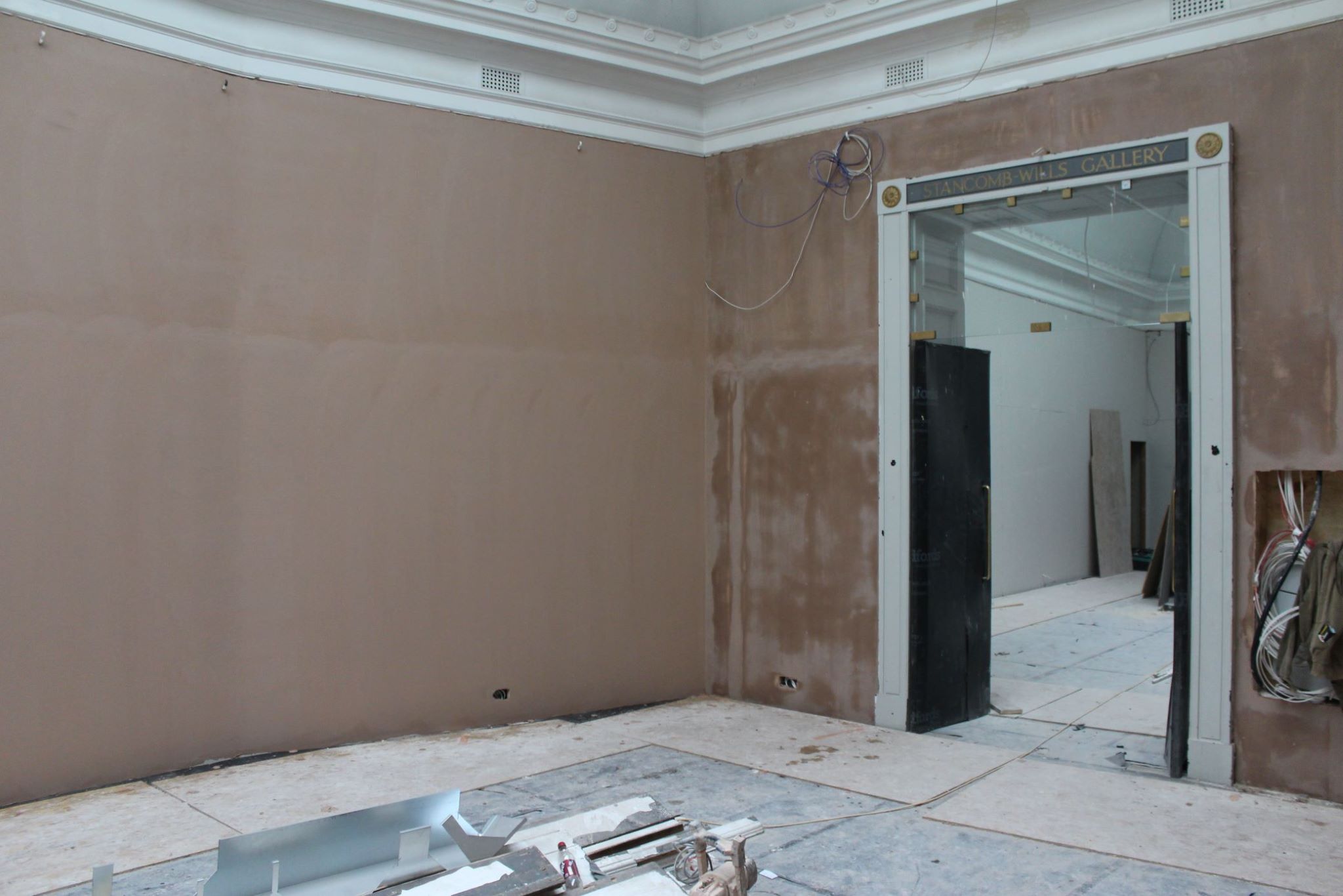 RWA gallery space and doorway with plaster visible on the walls 