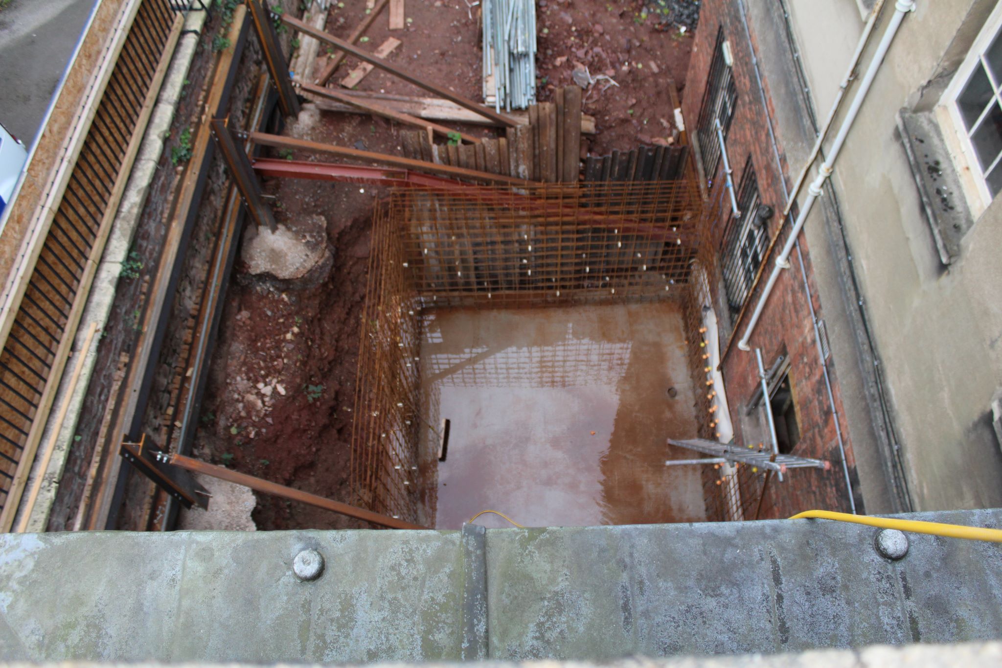 External building works looking down on a lift shaft pit 