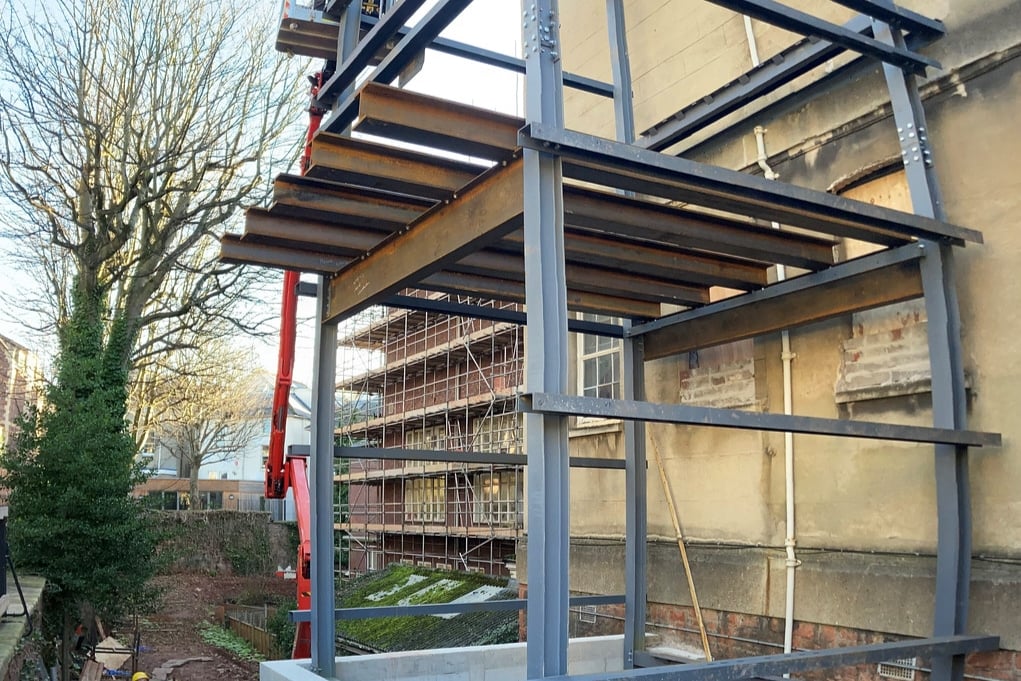 A large steelwork structure is installed to the side of the RWA building 