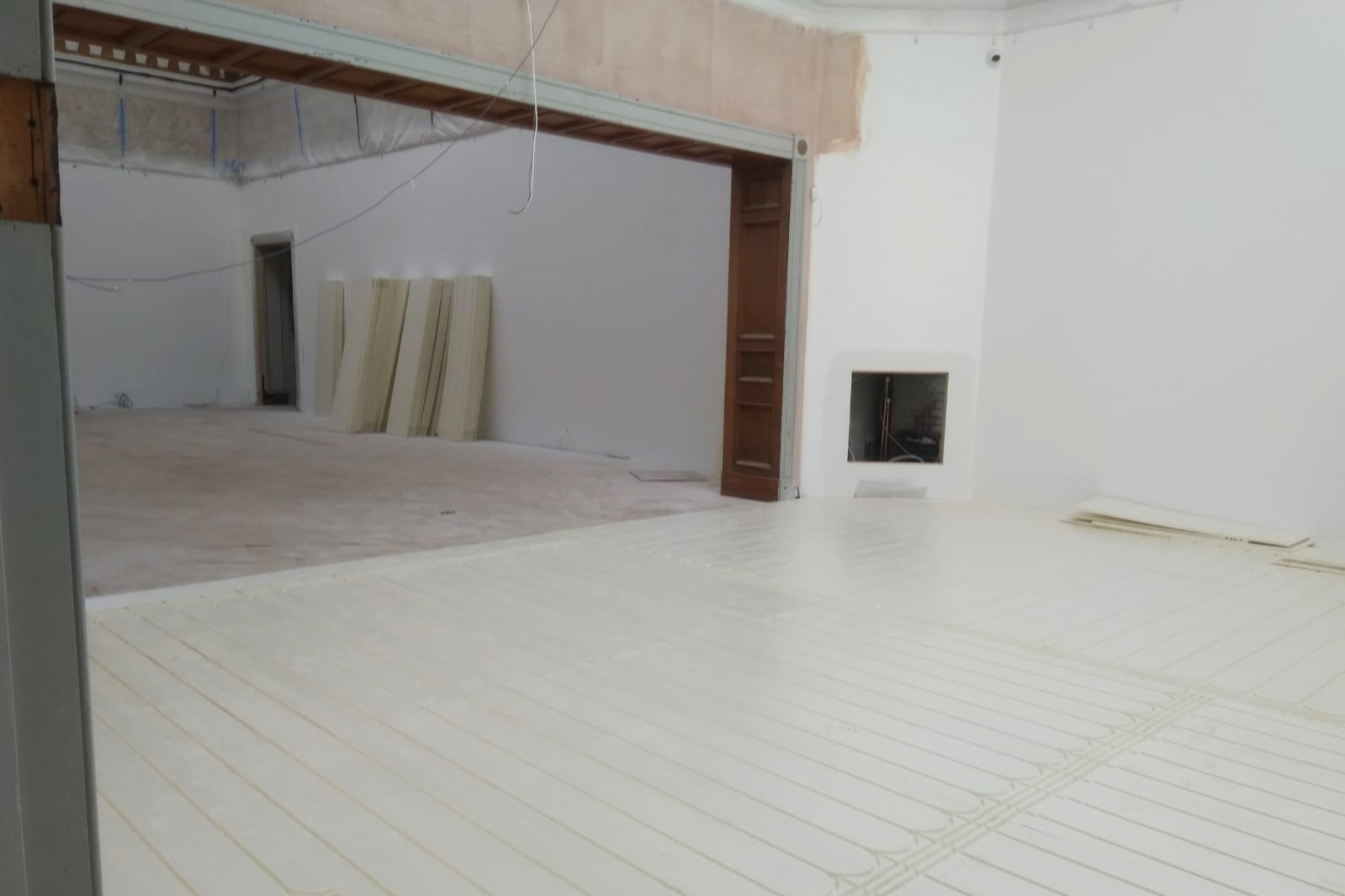 A large gallery space with white floor and white walls 