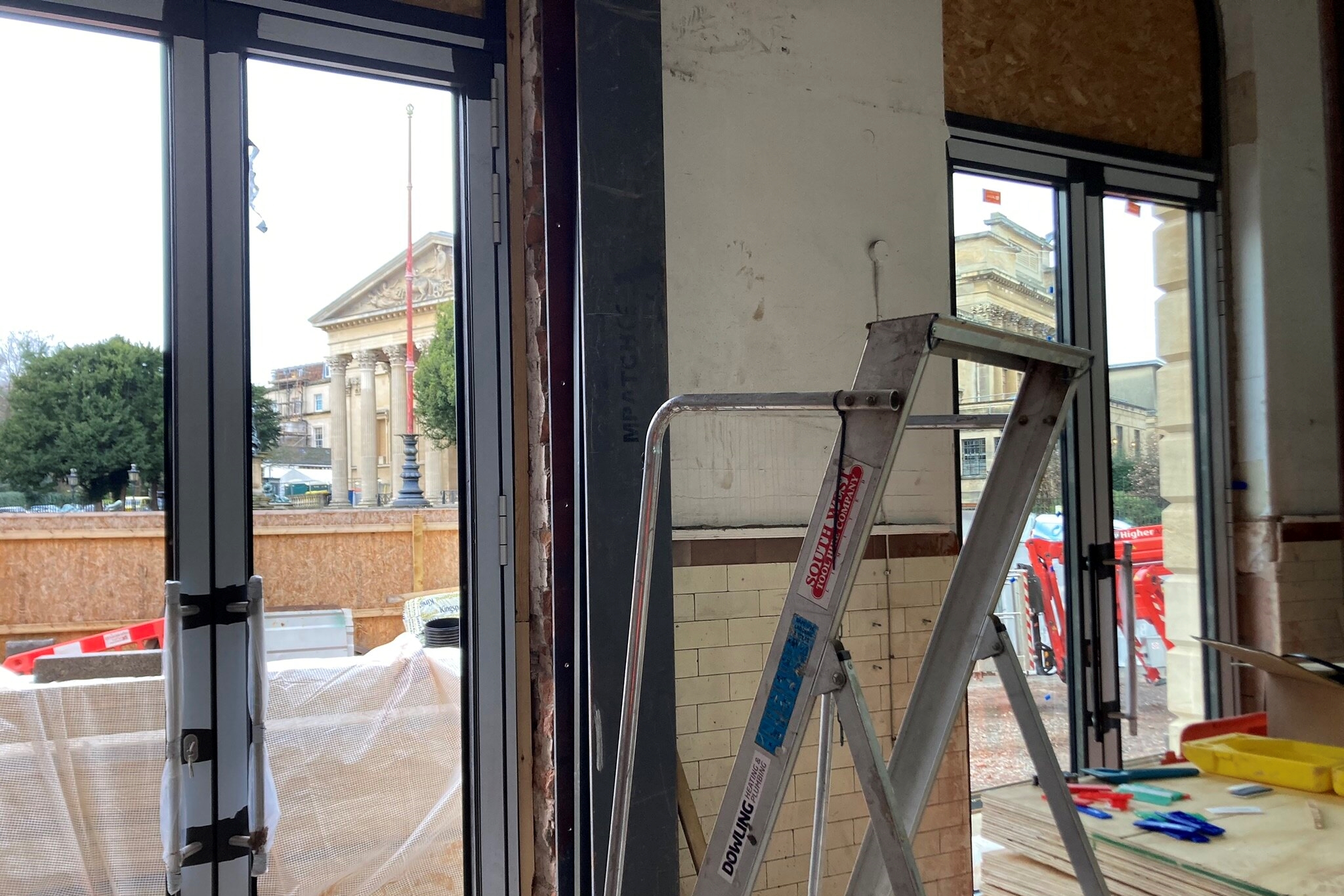 Two glass doors look out onto a street 