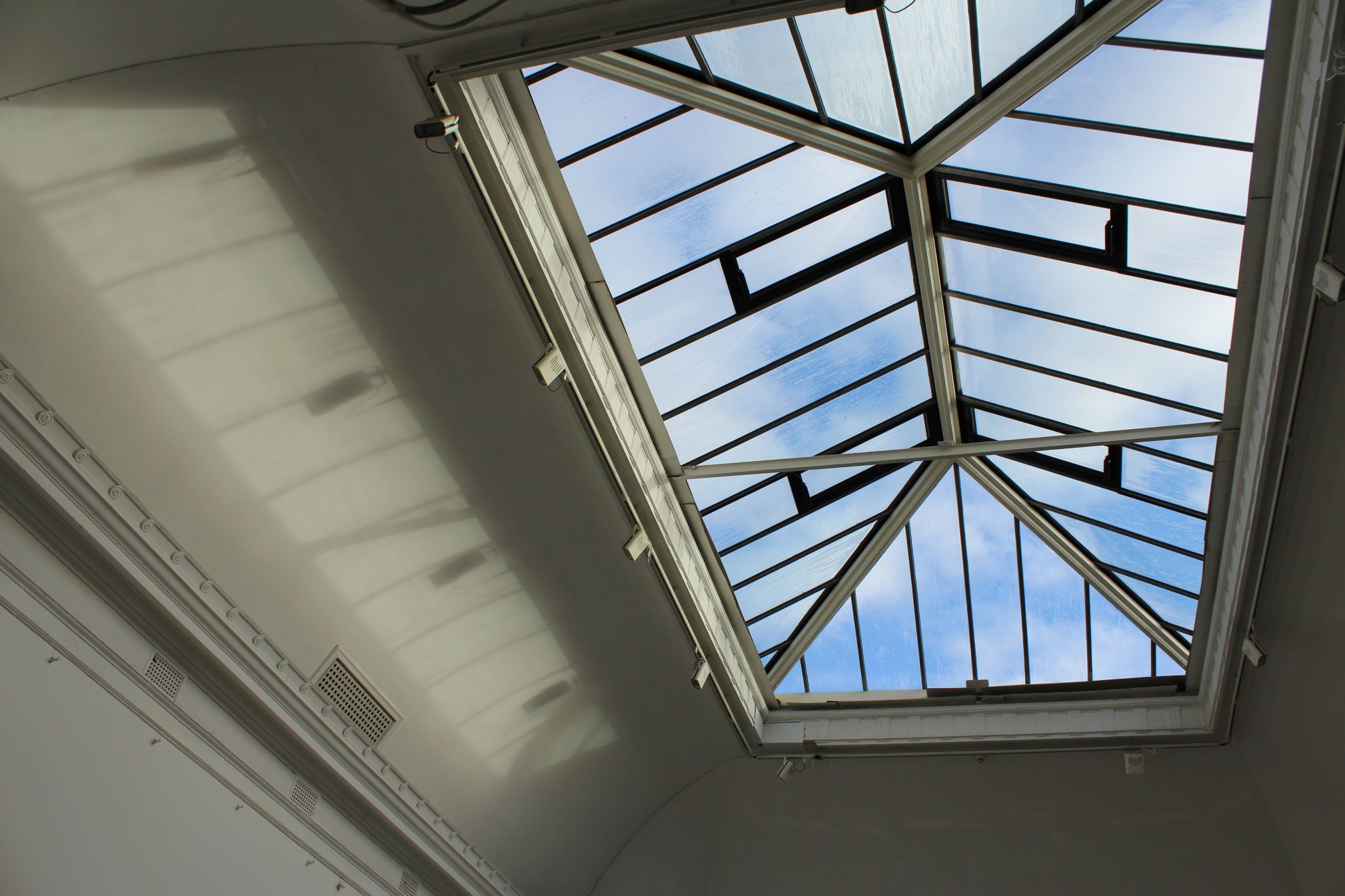 A large ceiling skylight with blue sky 