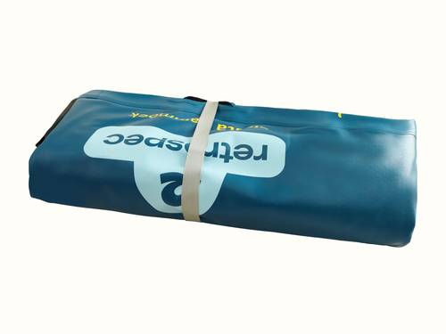 The Siesta Hammock Inflatable Water Platform -Circle 8' deflated and rolled up while being secured with a gray strap.