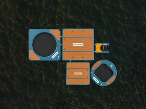 Aerial view of the Siesta floating platforms and hammocks on water, featuring circular and square sections with orange surfaces and interconnected design.