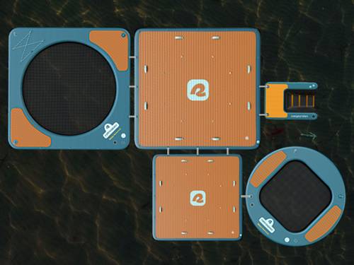 Aerial view of the Siesta floating platforms and hammocks on water, featuring circular and square sections with orange surfaces and interconnected design.