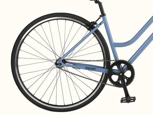 A close-up of a blue bicycle's rear wheel, chain, and pedal system.