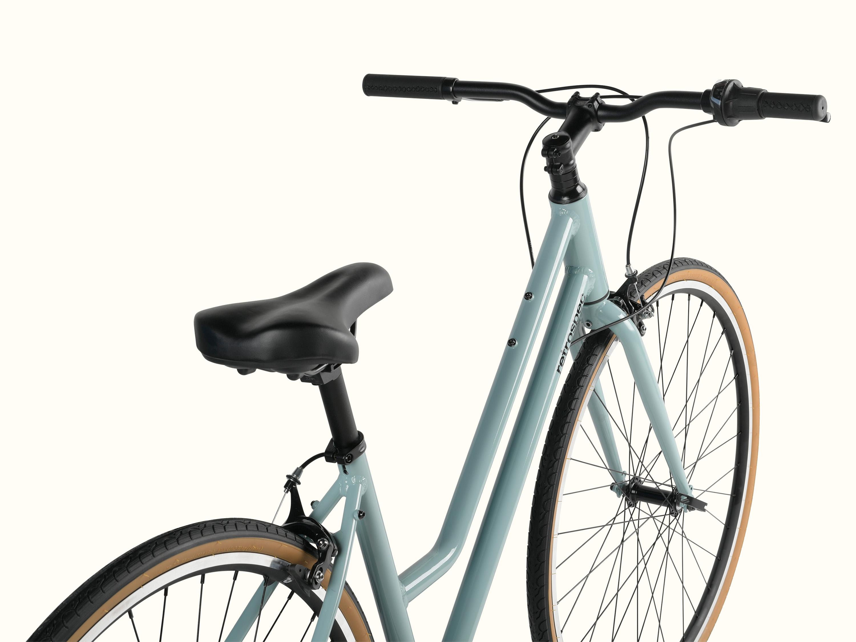 A close-up of a light blue Harper Plus 7-Speed bicycle with black handlebars and seat, isolated on a white background.