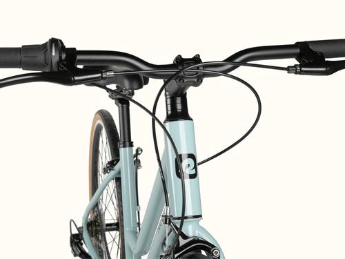 A close-up of a bicycle's handlebar and front fork against a white background.