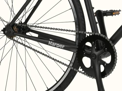 Close-up of a bicycle's rear wheel, chain, and pedal with "Harper" on the frame.