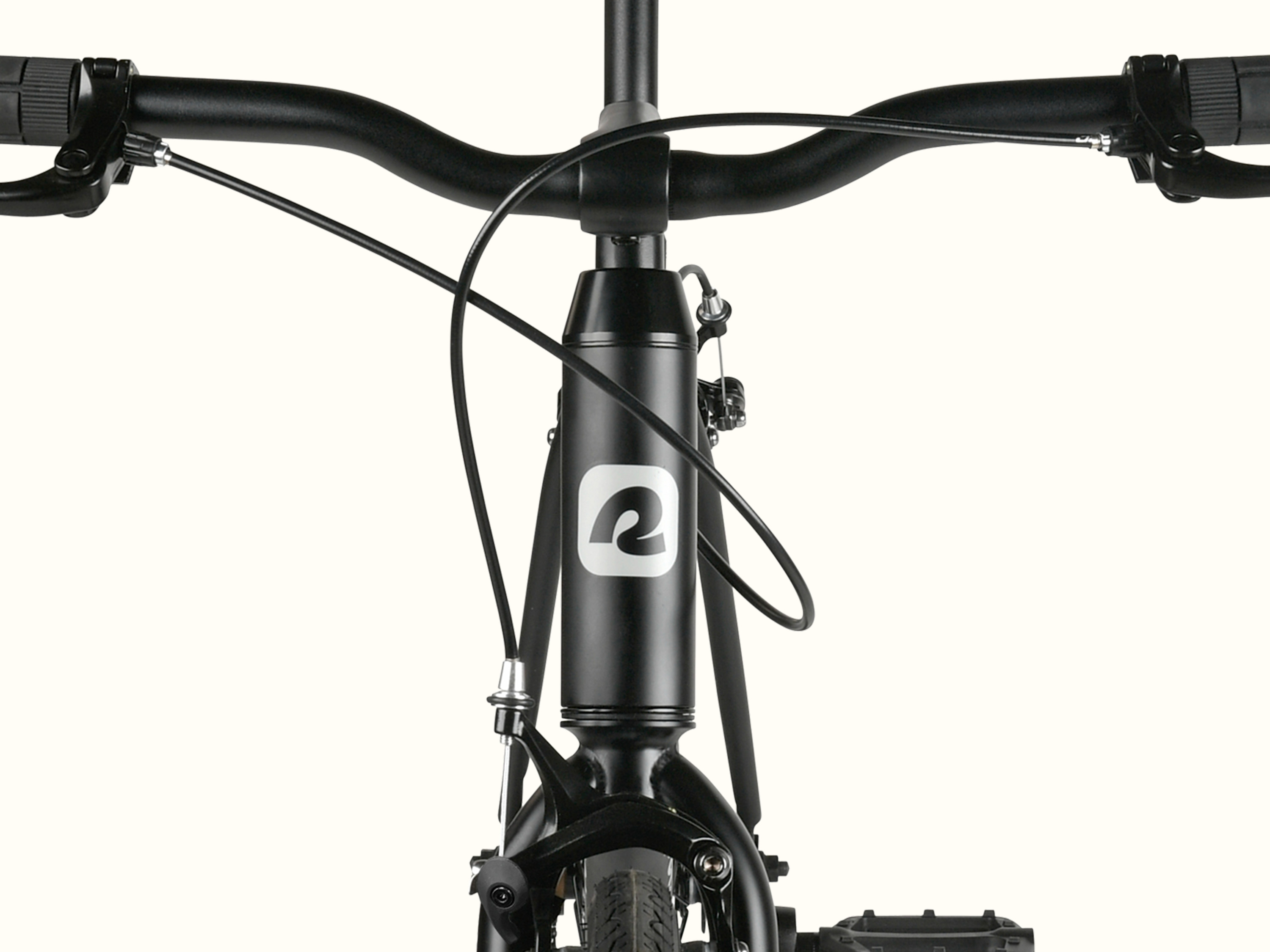 Close-up of a black bicycle's handlebar and head tube with a visible 