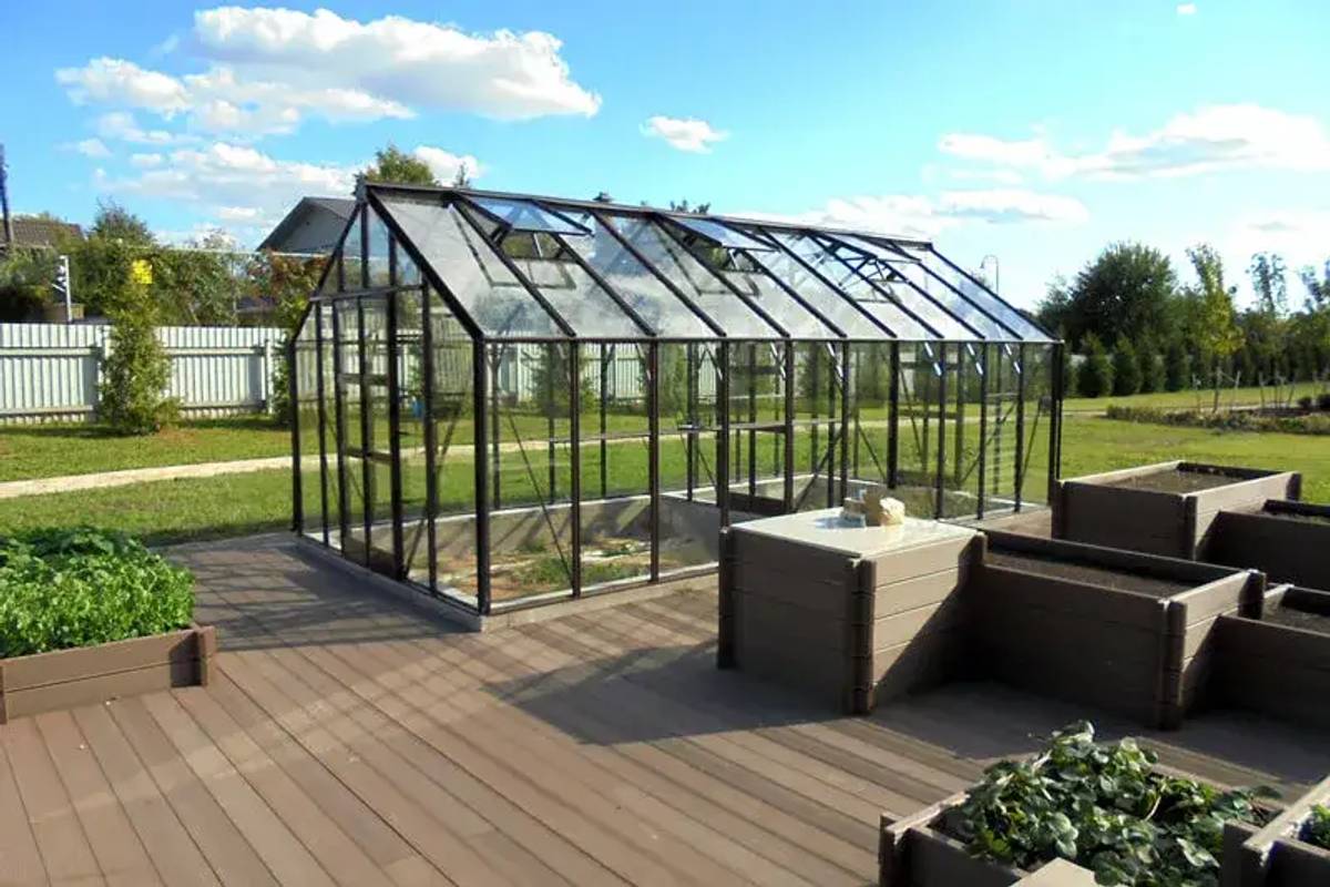 Titan greenhouse standing next to decked area