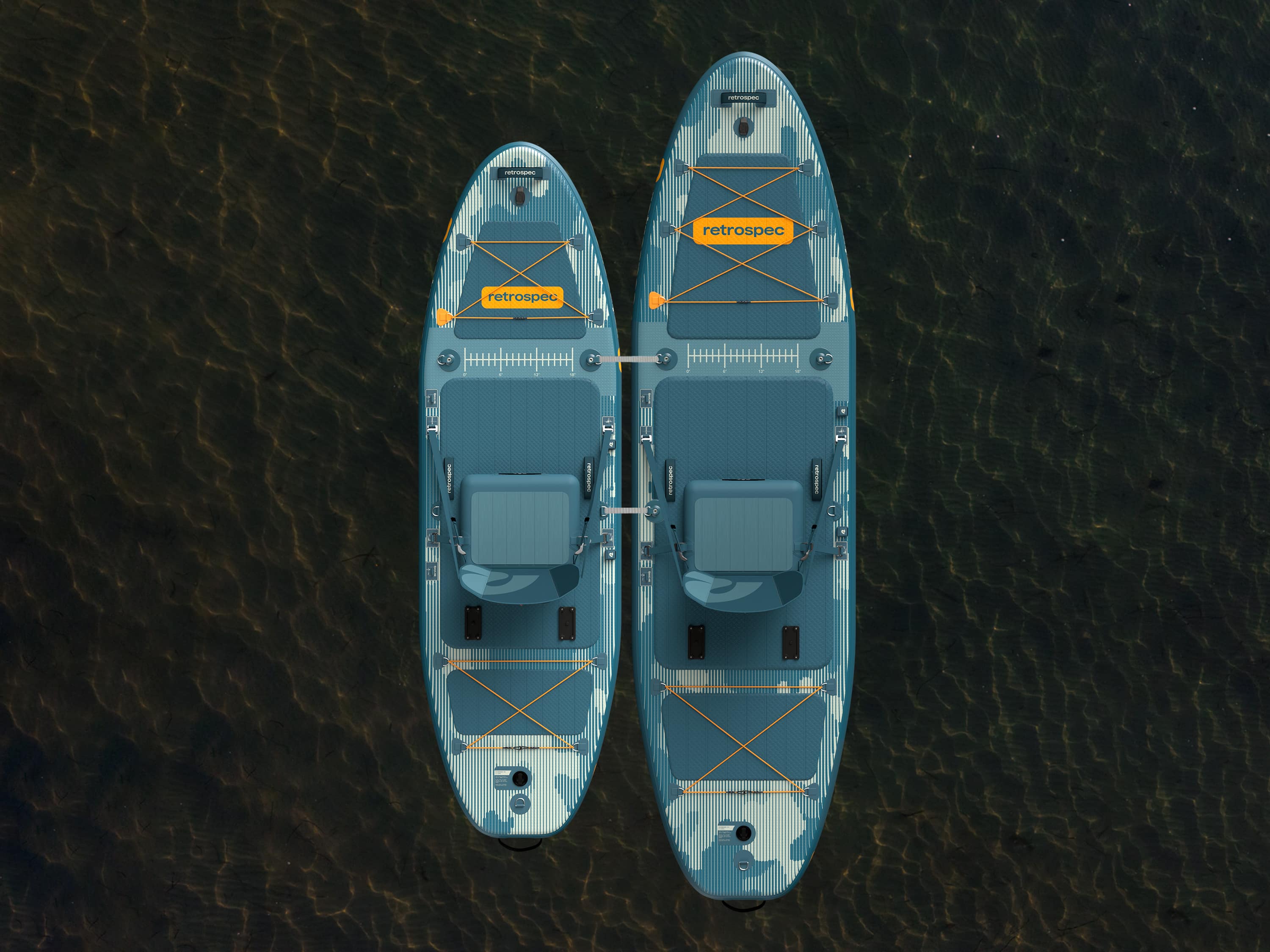 An aerial view of the June Inflatable Fishing Paddle Board Kayak Hybrid 11’6” and June Nano Kids’ Inflatable Fishing Paddle Board Kayak Hybrid tethered together on a calm body of water.