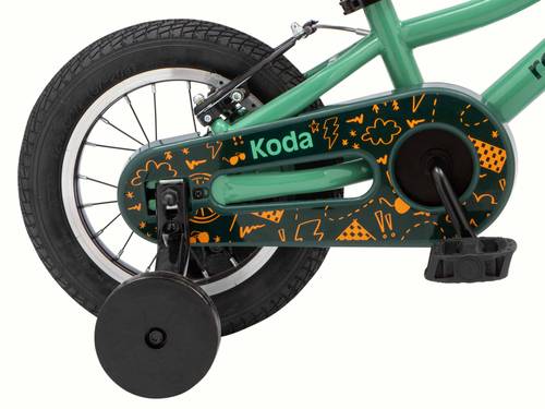 A kid's koda 12 inch green bicycle with a chain guard decorated with orange patterns and training wheels.