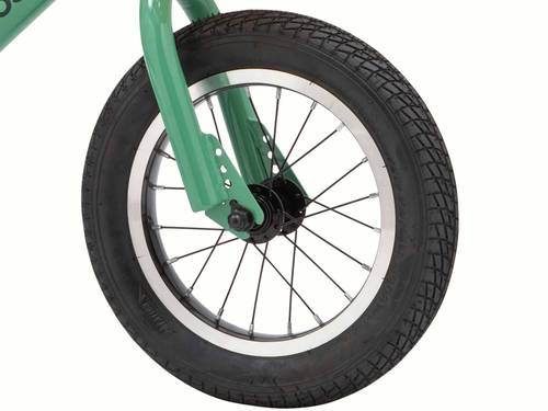 Close-up of a bicycle wheel with a green fork and focusing on the tread of the black tire.