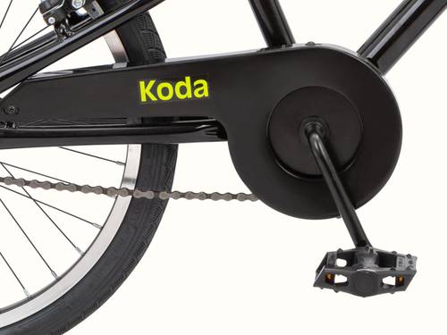 Close-up of a black bike's rear wheel, chain, and pedal, with the name "Koda" visible.