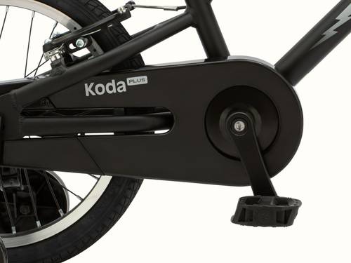 Close-up of black Koda Plus 16" Kids' Bicycle with focus on the "Koda Plus" branded chain guard and the pedal.