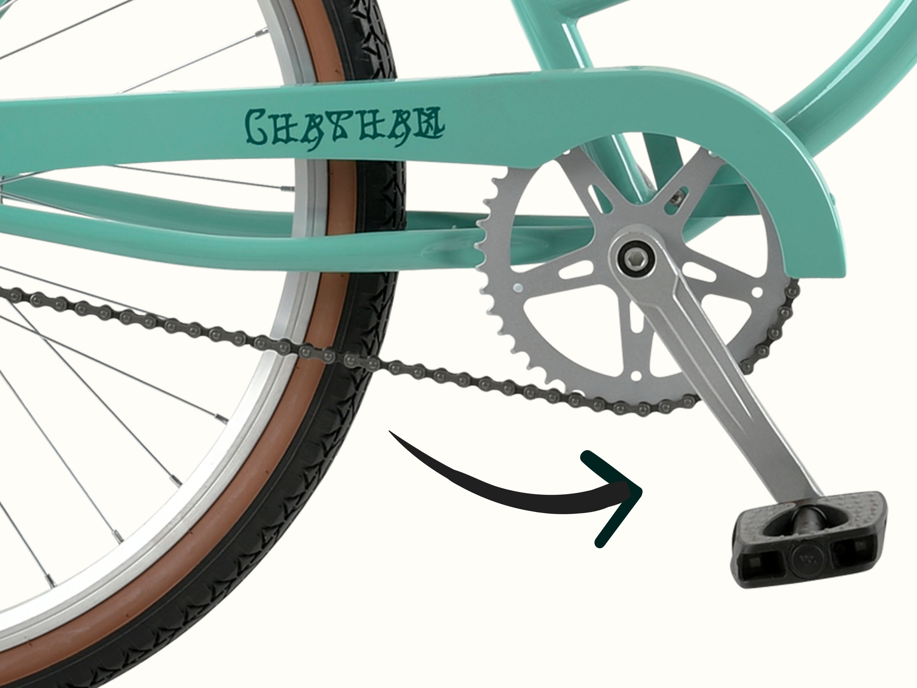 Close-up of a turquoise bicycle's chain and pedal system, featuring a silver crank and a brown-tinted tire. The brand name 
