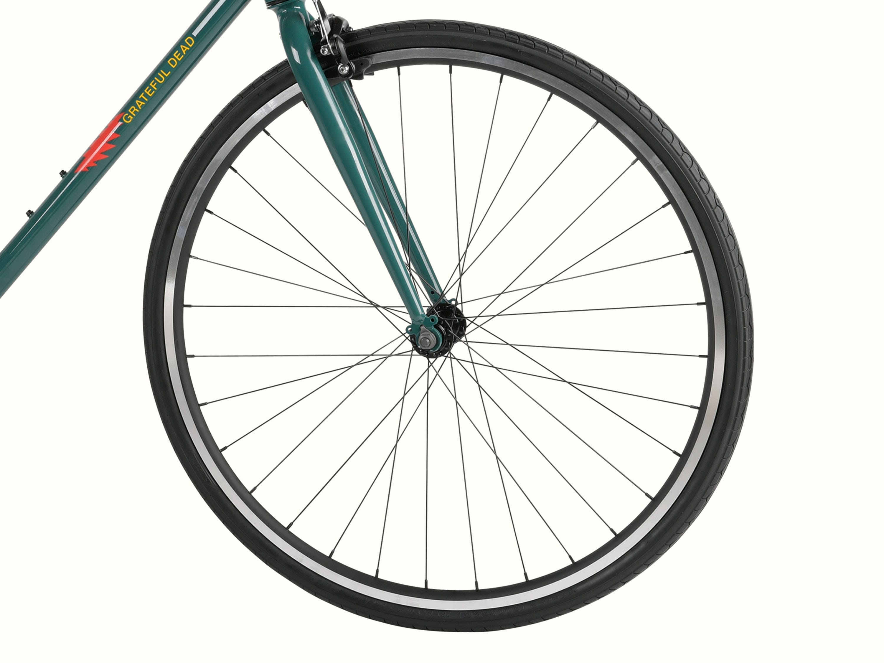 Close-up of a green Grateful Dead Harper Fixie Single Speed Bike's wheel featuring black spokes and a thin tire, with a colorful 