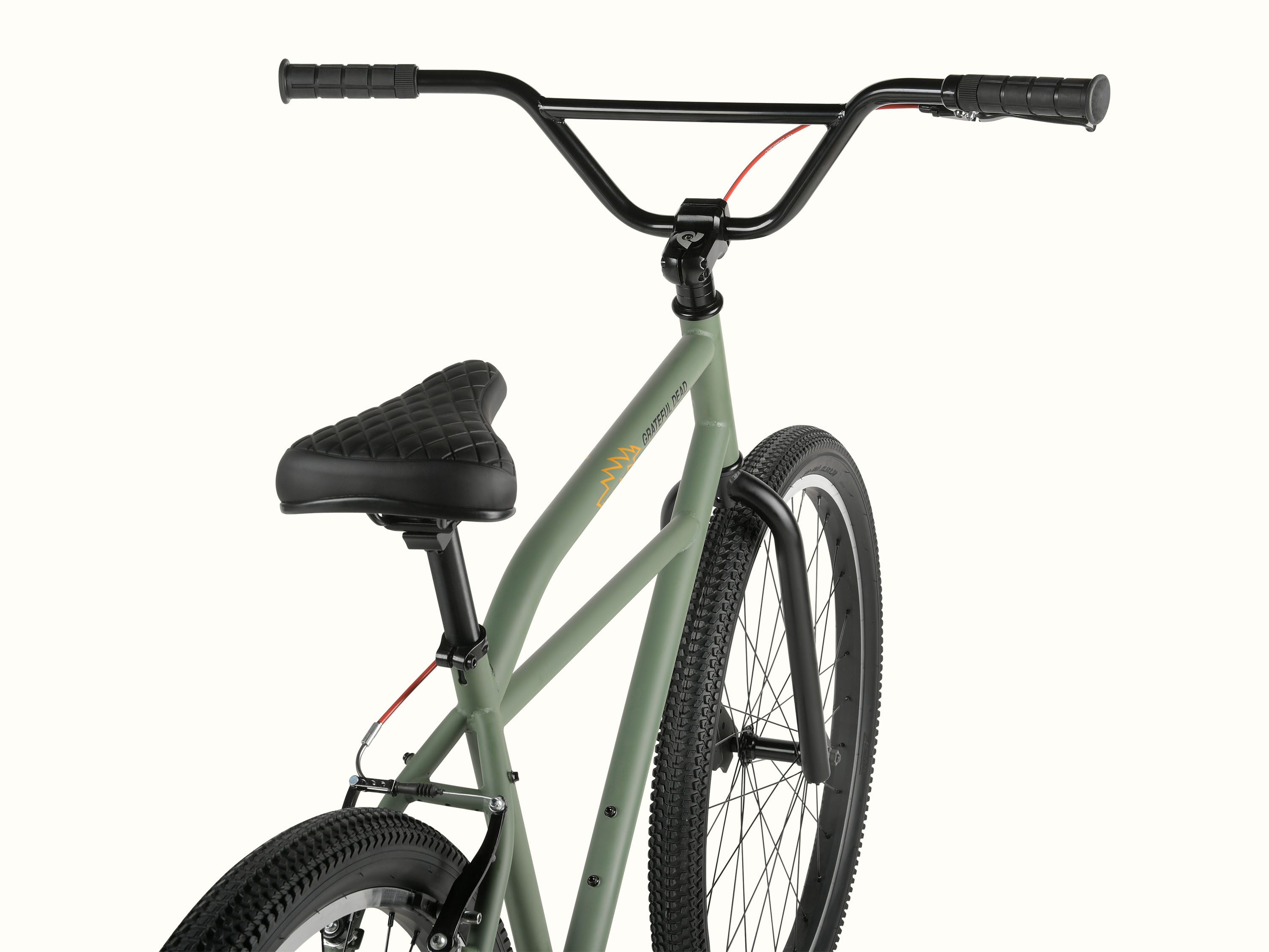 A close-up view of the olive green Grateful Dead Sully Klunker Single Speed Bicycle with black handlebars, a quilted black seat, and knobby tires, showcasing its sleek design.