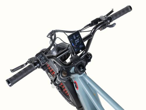 Close-up of the Grateful Dead Valen Rev+ Electric Fat Tire Bike's handlebar featuring a digital display, textured grips, and brake levers against a light background.