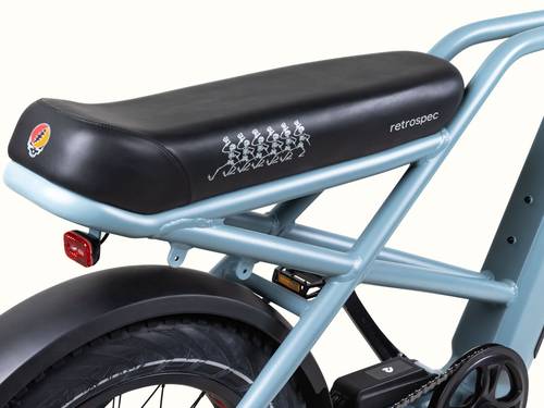 A close up of the stylish blue Grateful Dead Valen Rev+ Electric Fat Tire Bike's saddle featuring iconic Grateful Dead Dancing Skeletons and Grateful Dead Skull or "Steal Your Face" also known as "SYF" design.