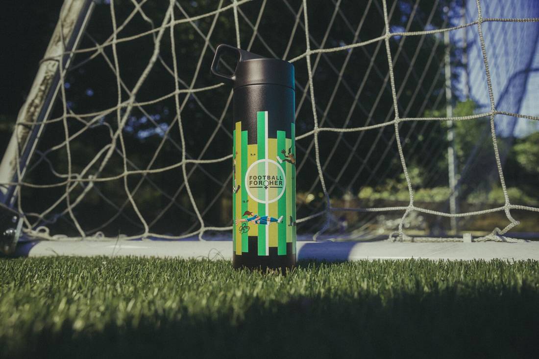 Close up of Lauren Barnes customized Football for Her Leakproof Straw Bottle in front of soccer goal.