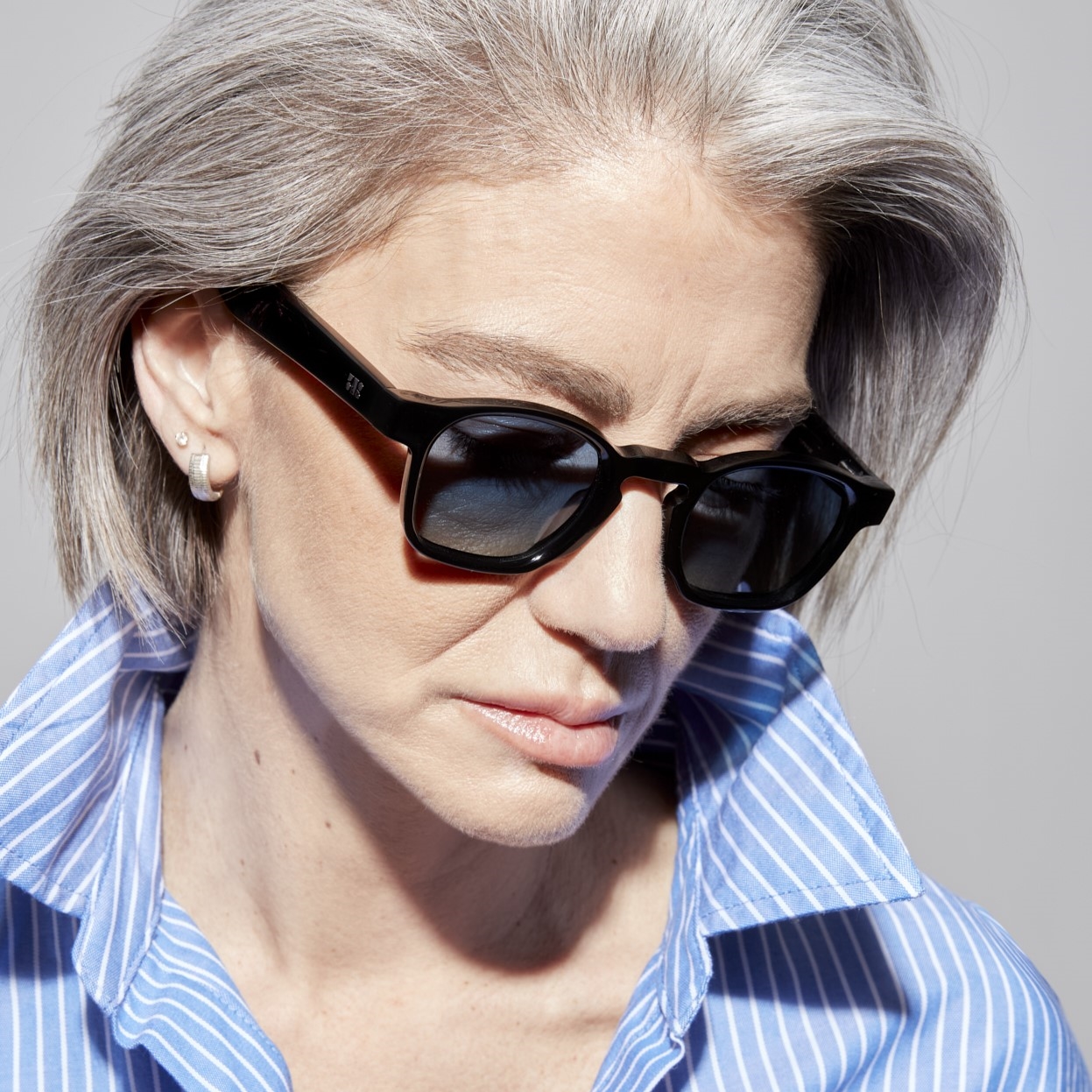 Photo of a man or woman wearing Enzo Sun Black & Blue Sun Glasses by French Kiwis