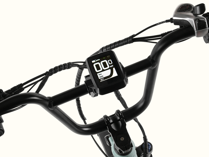 Close-up of an electric bicycle handlebar featuring a digital display showing speed and metrics, with black grips and a light green frame.