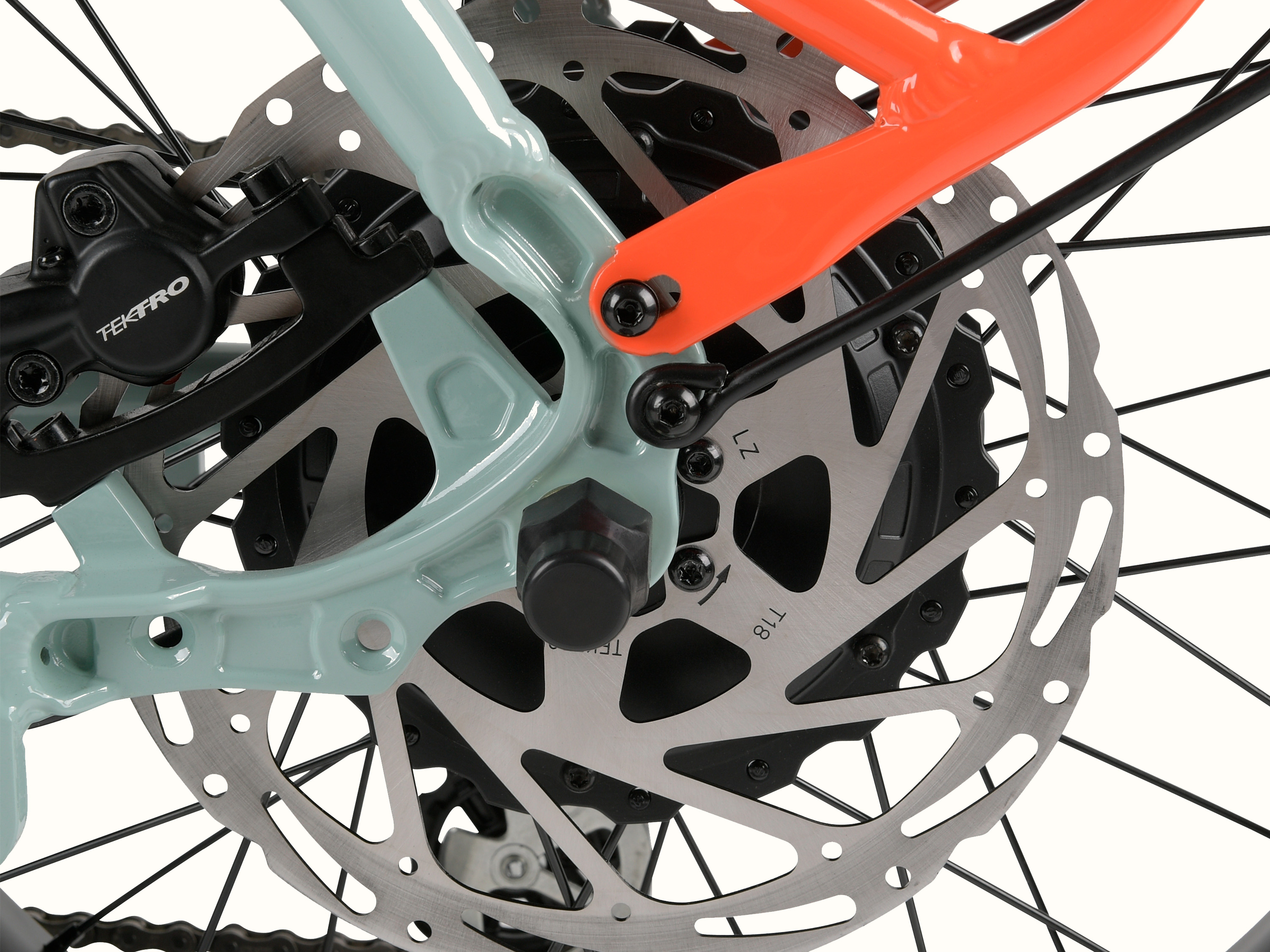 Close-up of am electric bicycle's rear disc brake assembly, highlighting the colorful brake caliper and intricate rotor design.