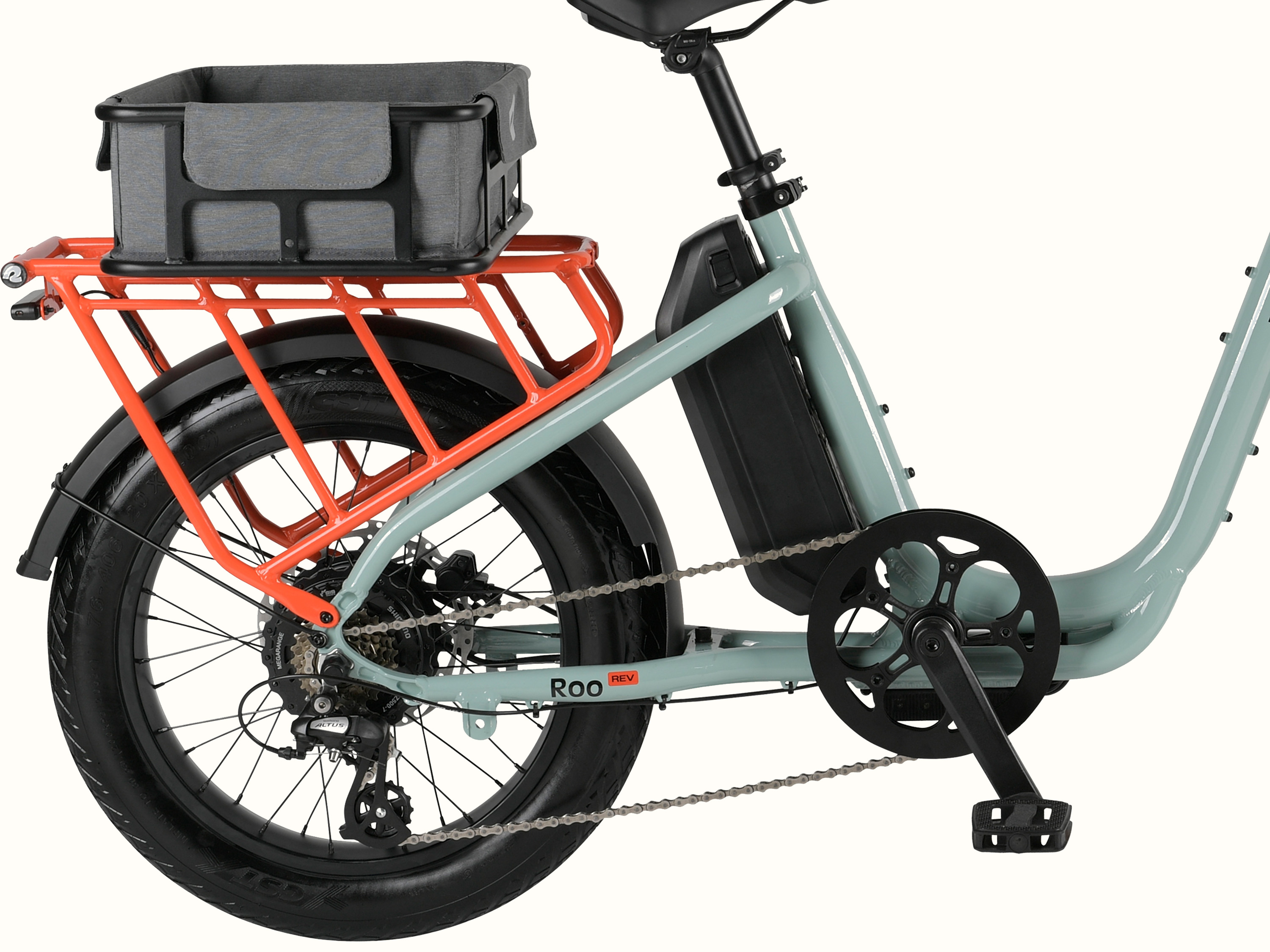 A closeup of the rear wheel and orange rear rack of an electric bike with a covered metal basket attached.