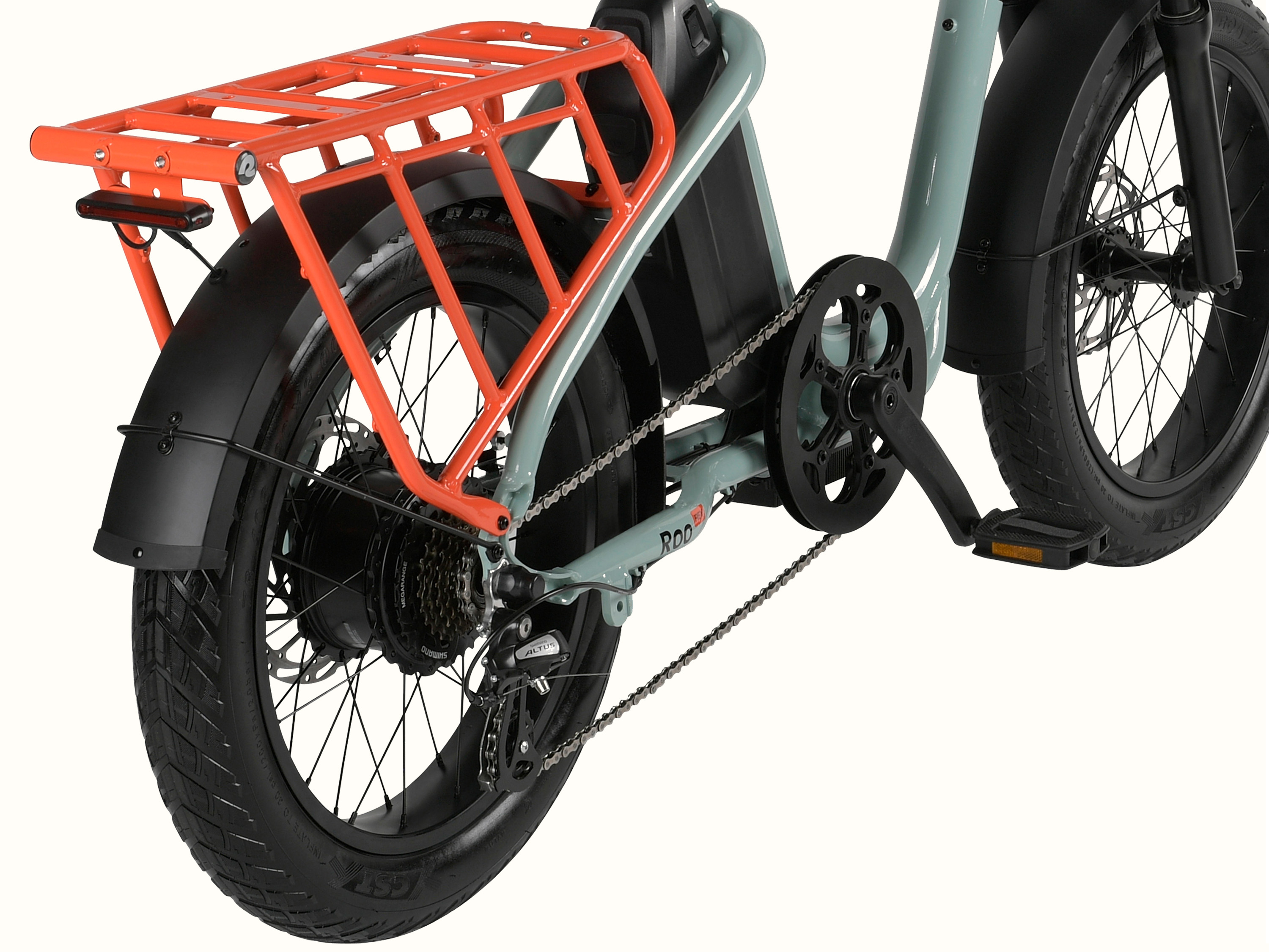 A close-up view of a mint green electric cargo bike's orange rear rack and fender.
