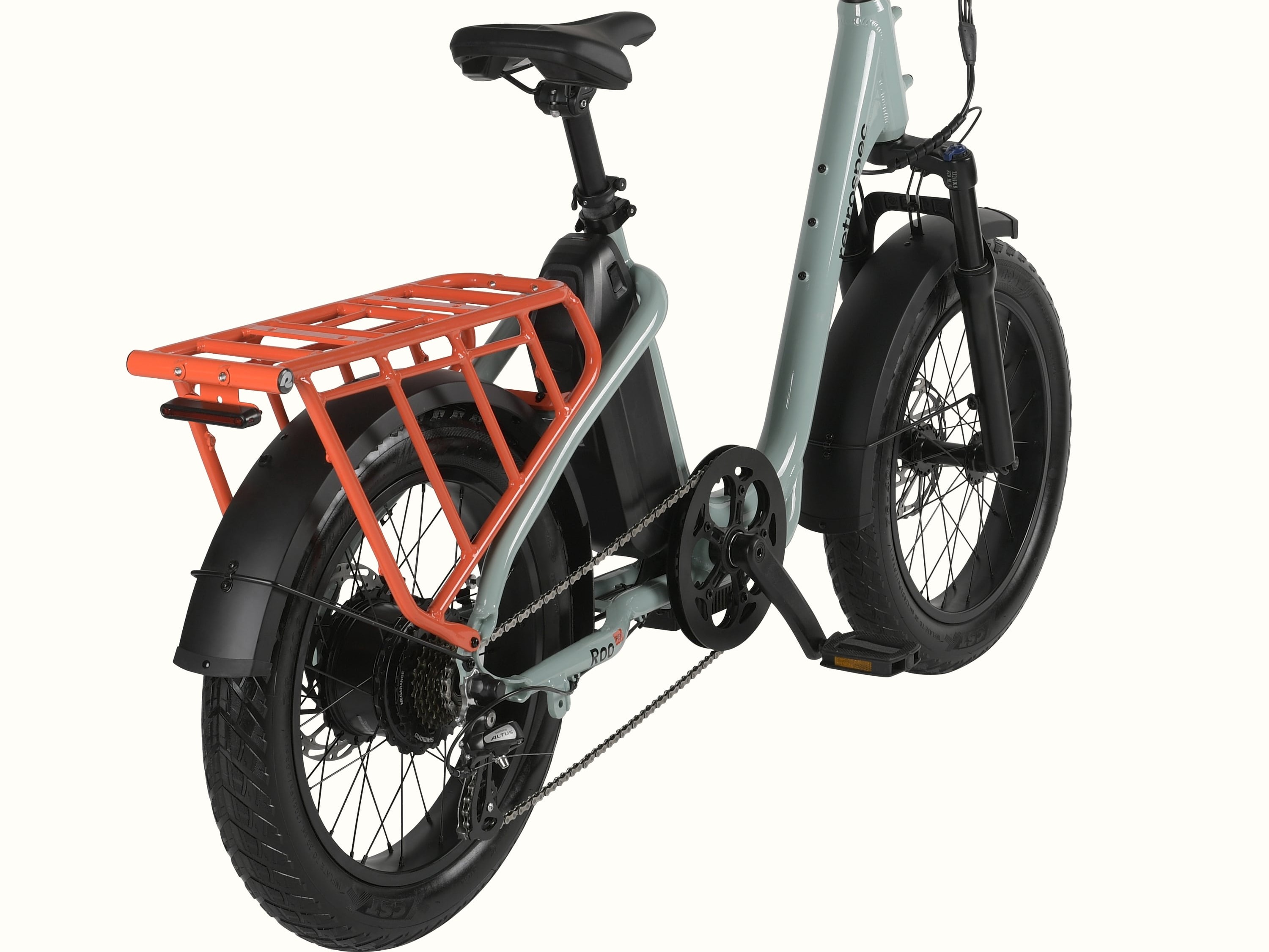 A close-up view of a mint green electric cargo bike's orange rear rack and fender.