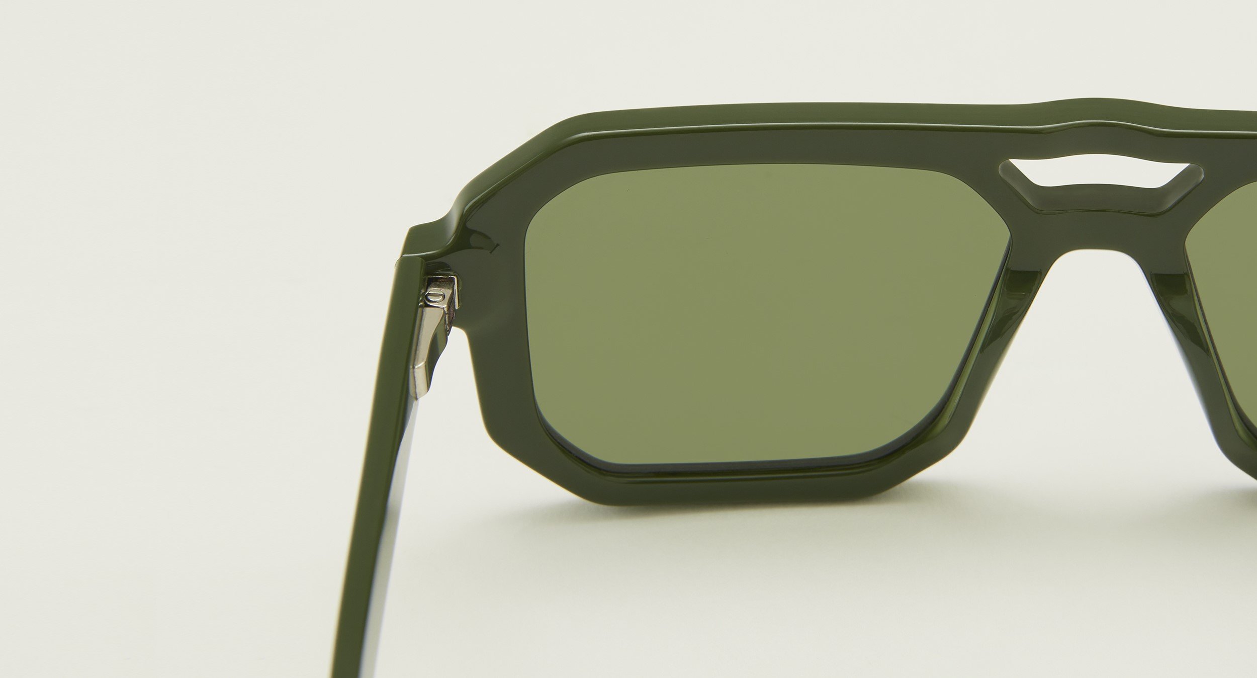 Photo Details of Angelo Blue Light Army Green Blue Light Glasses in a room