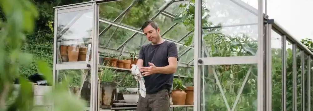 Gentleman cleaning his hands in his greenhouse