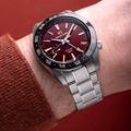 Grand Seiko SBGE305 Spring Drive GMT with red dial and black ceramic bezel. 