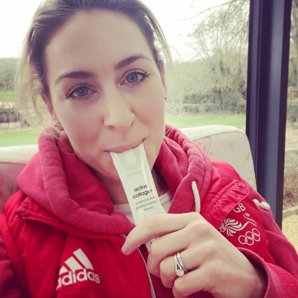 Amy Williams MBE OLY sitting down wearing a Team GB adidas jacket and taking a U Perform Active Collagen gel recovery supplement product