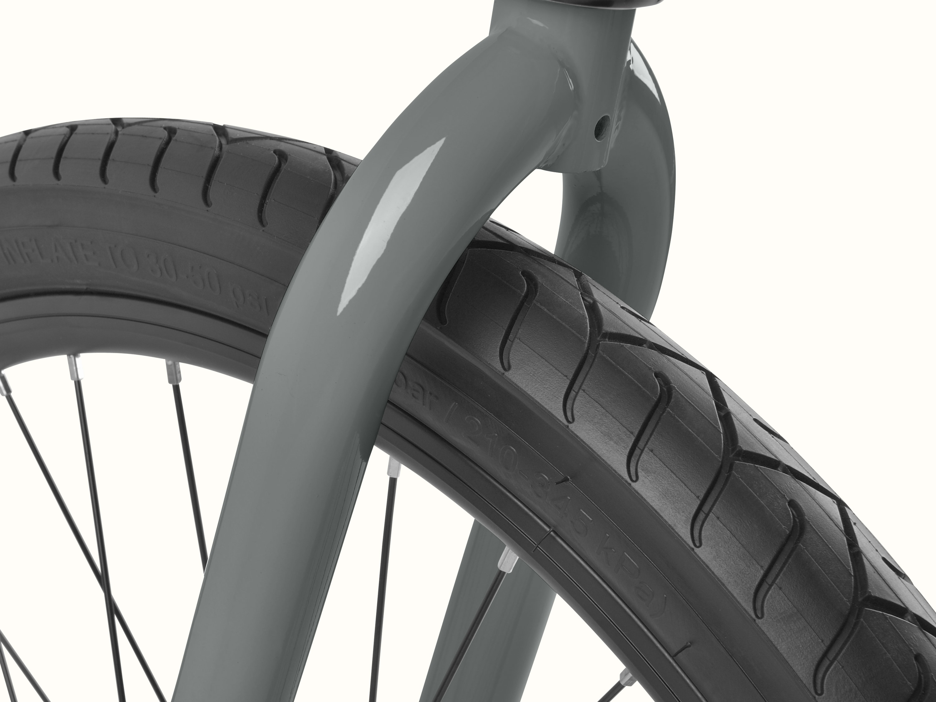 Retrospec Montauk Step Through bike in Graphite, close-up of the front fork and wide black tire with a subtle tread pattern, built for smooth cruising on any surface.
