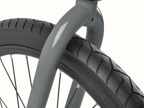 Retrospec Montauk Step Through bike in Graphite, close-up of the front fork and wide black tire with a subtle tread pattern, built for smooth cruising on any surface.