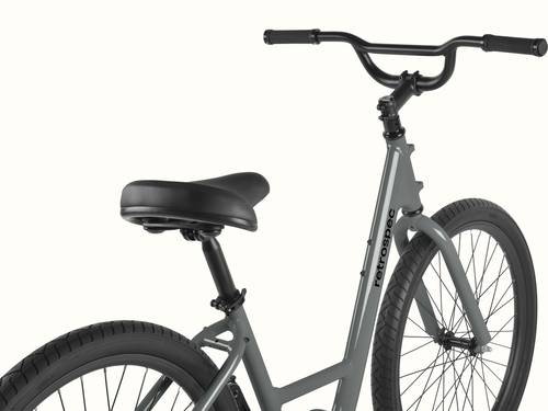 Close-up of the Montauk step through's cushioned black saddle and adjustable seat post, with a quick-release clamp for easy height adjustment and the retrospec down tube logo visible in the background.