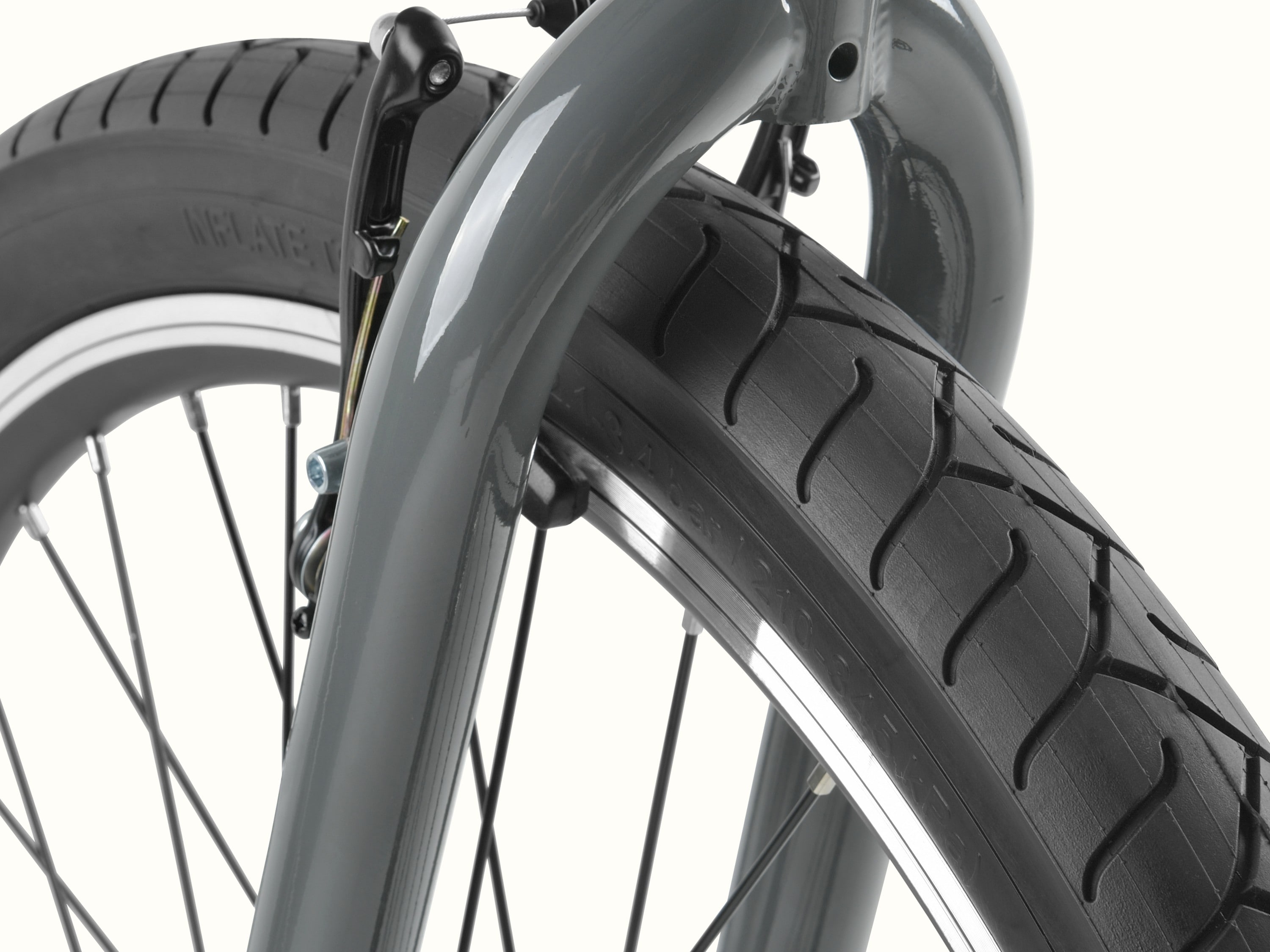 Close-up of the Montauk 26's wide tread tire and graphite-painted fork, showing the smooth tread pattern and sturdy construction built for easy, confident riding.