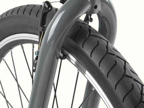 Close-up of the Montauk 26's wide tread tire and graphite-painted fork, showing the smooth tread pattern and sturdy construction built for easy, confident riding.