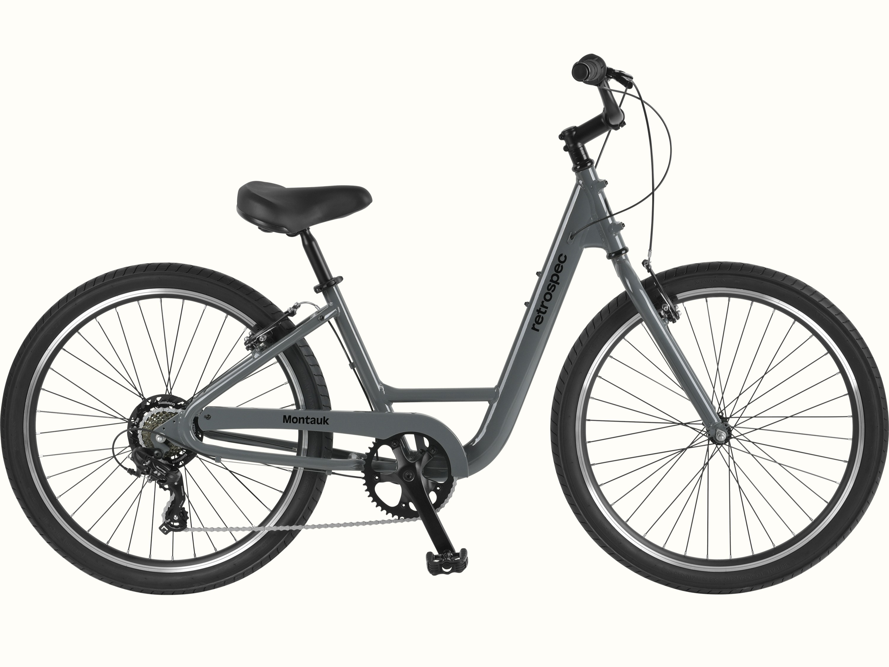 retrospec Montauk step through cruiser 7 Speed bike in Graphite with a step-through frame, black saddle, and single-speed drivetrain, shown in a full side profile on a clean white background.